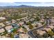 An aerial view of a neighborhood showcasing homes with desert landscaping and mountain views at 4607 E Rancho Laredo Dr, Cave Creek, AZ 85331