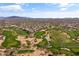 Breathtaking aerial view of the golf course highlighting lush fairways, desert landscaping, and stunning mountain backdrop at 4607 E Rancho Laredo Dr, Cave Creek, AZ 85331