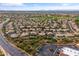 An aerial view showcases homes in a desert community near a retail shopping center and parking at 4607 E Rancho Laredo Dr, Cave Creek, AZ 85331