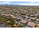 A high aerial view features desert homes with lush backyards and private pools at 4607 E Rancho Laredo Dr, Cave Creek, AZ 85331