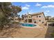 Aerial view of backyard featuring a pool, covered patio, built-in BBQ, and mature landscaping at 4607 E Rancho Laredo Dr, Cave Creek, AZ 85331