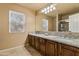 Bathroom featuring double sinks, granite countertops, and decorative lighting at 4607 E Rancho Laredo Dr, Cave Creek, AZ 85331