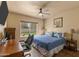 A well-lit bedroom featuring a ceiling fan, work space, and view of the back yard at 4607 E Rancho Laredo Dr, Cave Creek, AZ 85331