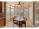 A dining area with large windows features a ceiling fan and adjacent access to the yard at 4607 E Rancho Laredo Dr, Cave Creek, AZ 85331