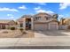 Charming tan two-story home featuring a well-maintained yard and attached two-car garage at 4607 E Rancho Laredo Dr, Cave Creek, AZ 85331