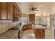 Bright and airy kitchen features wood cabinets, a tile backsplash, and an island with seating at 4607 E Rancho Laredo Dr, Cave Creek, AZ 85331