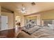 Large main bedroom with hardwood floors and a ceiling fan, leads to a spa-like bathroom at 4607 E Rancho Laredo Dr, Cave Creek, AZ 85331