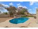 Inviting pool area with a built-in BBQ, seating area, and lush landscaping for privacy at 4607 E Rancho Laredo Dr, Cave Creek, AZ 85331