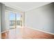 Light-filled bedroom with wood floors and a sliding glass door that opens to a balcony at 4750 N Central Ave # 12H, Phoenix, AZ 85012