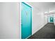 Hallway leading to unit 112H with a turquoise colored door at 4750 N Central Ave # 12H, Phoenix, AZ 85012