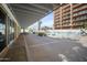 Outdoor patio area with a pool view, tables and chairs, and a covered walkway at 4750 N Central Ave # 12H, Phoenix, AZ 85012