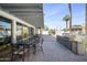 A covered patio featuring dining tables, chairs, and an outdoor grilling area at 4750 N Central Ave # 12H, Phoenix, AZ 85012