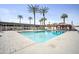 Beautiful outdoor pool with palm trees and lounge seating under a clear blue sky at 4750 N Central Ave # 12H, Phoenix, AZ 85012