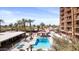 An inviting outdoor pool is surrounded by palm trees and lounge chairs, offering a perfect escape at 4750 N Central Ave # 12H, Phoenix, AZ 85012