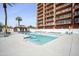 A pristine outdoor pool with clear blue water, lounge chairs, and a gazebo at 4750 N Central Ave # 12H, Phoenix, AZ 85012