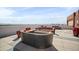 Community rooftop patio with circular seating arrangement and a built in fire pit at 4750 N Central Ave # 12H, Phoenix, AZ 85012