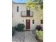 Charming home featuring a red front door, balcony, and desert landscaping, providing a welcoming curb appeal at 4818 N 73Rd St, Scottsdale, AZ 85251