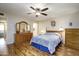 Bright bedroom showcasing a large dresser, wood floors, and a ceiling fan at 518 S Racine --, Mesa, AZ 85206