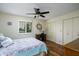 Well-lit bedroom with a ceiling fan, plantation shutters, and wood-look flooring at 518 S Racine --, Mesa, AZ 85206