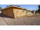 Exterior view of the home's red brick and beige trim, with a screened room visible from the side of the house at 518 S Racine --, Mesa, AZ 85206