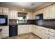 Inviting kitchen featuring neutral cabinets, black appliances, and a window with a backyard view at 518 S Racine --, Mesa, AZ 85206