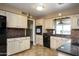 Well-lit kitchen with neutral cabinets, black appliances, and tile backsplash at 518 S Racine --, Mesa, AZ 85206