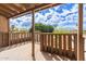 Balcony with wood railing overlooking green trees and beautiful sky at 5513 N 5Th Dr, Phoenix, AZ 85013