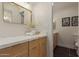 Bathroom featuring dual sink vanity with modern fixtures, quartz countertops, and wood-look cabinets at 5513 N 5Th Dr, Phoenix, AZ 85013