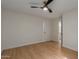 Bright bedroom features modern ceiling fan, neutral walls, and wood-look flooring at 5513 N 5Th Dr, Phoenix, AZ 85013