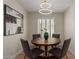 Bright dining room with round table, four chairs, and modern light fixture at 5513 N 5Th Dr, Phoenix, AZ 85013