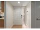 Bright entry foyer featuring a white front door, light wood floors, and clean, neutral walls at 5513 N 5Th Dr, Phoenix, AZ 85013