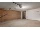 Spacious garage with brick accent wall, concrete flooring, and storage shelves at 5513 N 5Th Dr, Phoenix, AZ 85013