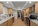 Bright kitchen with white stone countertops, wood cabinets, and stainless-steel appliances at 5513 N 5Th Dr, Phoenix, AZ 85013