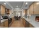 Modern kitchen open to dining room with beautiful white counters, cabinets, and stainless appliances at 5513 N 5Th Dr, Phoenix, AZ 85013