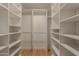 Spacious walk-in closet featuring custom shelving and ample storage solutions at 5513 N 5Th Dr, Phoenix, AZ 85013