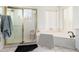 Bathroom showing a glass enclosed shower and large bathtub at 5771 W Gail Dr, Chandler, AZ 85226