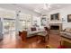 Inviting living room with stone fireplace, hardwood floors, and abundant natural light at 5771 W Gail Dr, Chandler, AZ 85226