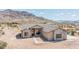 Stunning single-story home with stone accents and desert landscaping against a backdrop of picturesque mountains at 6107 E Lone Mountain Rd, Cave Creek, AZ 85331