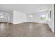 Spacious living room with wood-look tile flooring, white walls, recessed lighting, and ample natural light at 6107 E Lone Mountain Rd, Cave Creek, AZ 85331