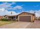 Inviting single-story home with a spacious driveway and well-manicured front yard at 6225 W Marconi Ave, Glendale, AZ 85306