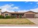 Charming single story home with beautiful desert landscaping, covered porch, and brown two car garage at 6225 W Marconi Ave, Glendale, AZ 85306