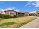 Landscaped front yard with fresh green grass and plants at 6225 W Marconi Ave, Glendale, AZ 85306