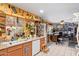 Open kitchen with wood cabinetry, white appliances, and tile flooring, seamlessly transitioning to the rest of the home at 6225 W Marconi Ave, Glendale, AZ 85306