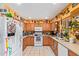 Well-appointed kitchen featuring wooden cabinets, white appliances, and a large sink, ready for all your culinary needs at 6225 W Marconi Ave, Glendale, AZ 85306