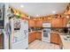 This bright kitchen features wooden cabinets, modern appliances, and lots of decorative items creating a warm atmosphere at 6225 W Marconi Ave, Glendale, AZ 85306