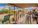 The covered patio offers shaded seating, colorful stools, and a view of the landscaped backyard at 6225 W Marconi Ave, Glendale, AZ 85306