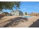 Expansive backyard with desert landscaping featuring a pristine in-ground pool at 6993 S Sharon Ct, Chandler, AZ 85249