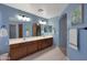 Bathroom featuring dual sinks, dark wood cabinets and neutral walls at 6993 S Sharon Ct, Chandler, AZ 85249