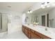 Bright bathroom features a double vanity, a large mirror, and a shower/tub combo at 6993 S Sharon Ct, Chandler, AZ 85249