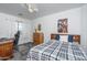 Bright secondary bedroom featuring neutral walls, a bed, and a ceiling fan at 6993 S Sharon Ct, Chandler, AZ 85249